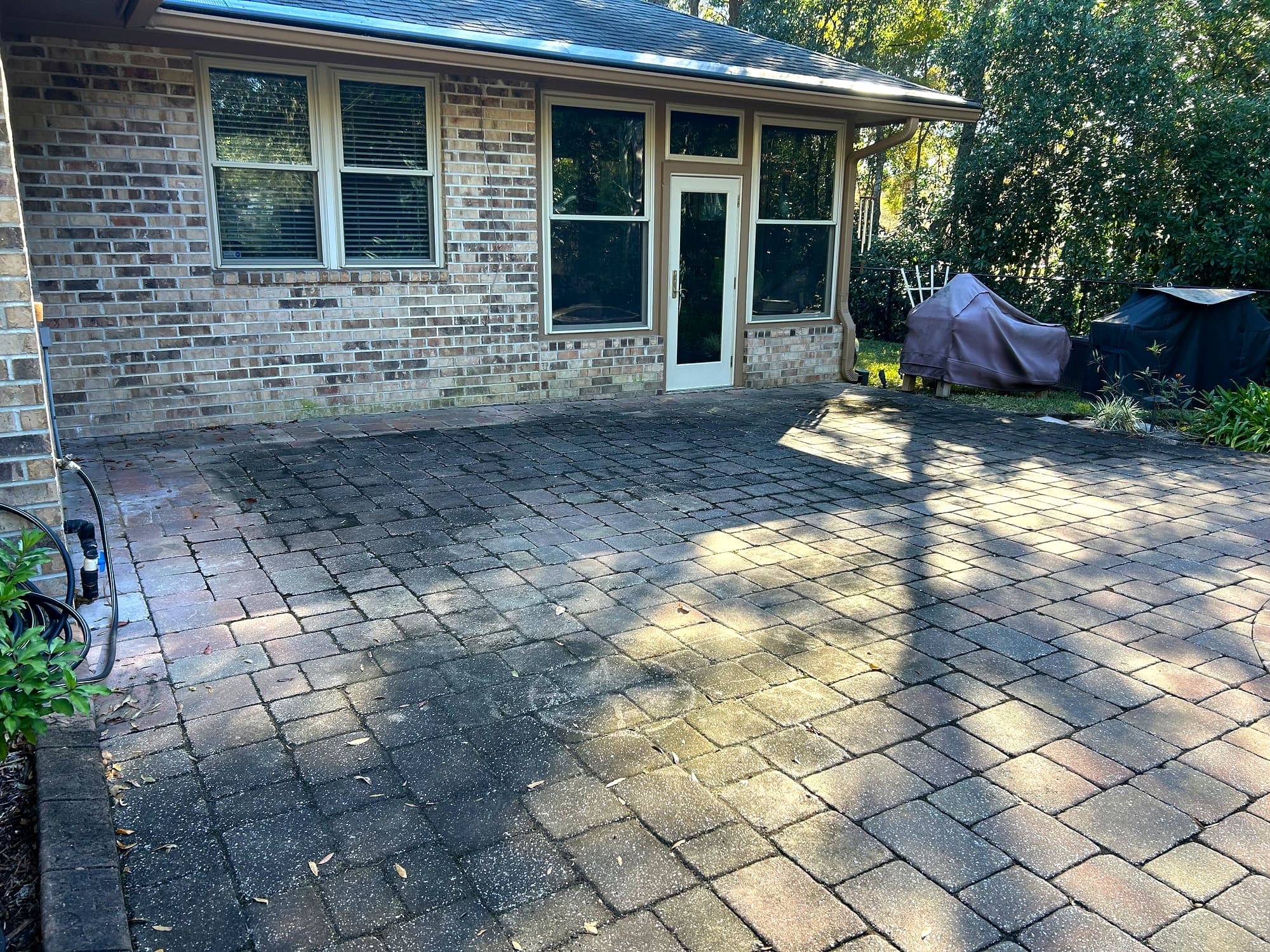 A cleaned paver driveway and patio at a Jacksonville home.